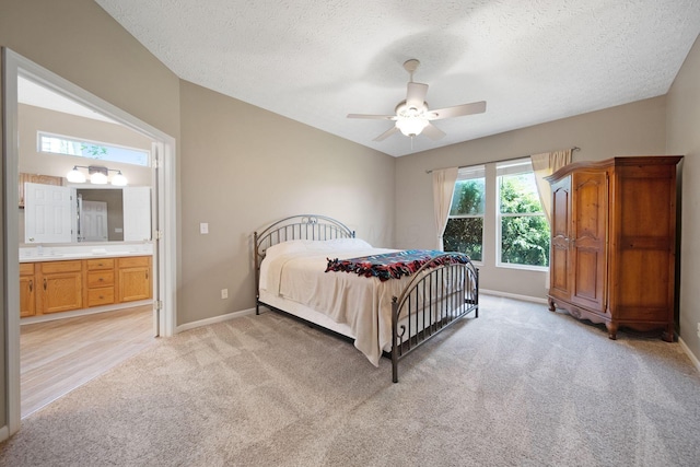 272 Trail E, Etna, OH 43062 - bedroom with light colored carpet, baseboards, a textured ceiling, ensuite bathroom, and a sink