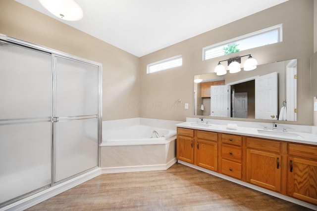 272 Trail E, Etna, OH 43062 - full bath featuring double vanity, a bath, a shower stall, and wood finished floors