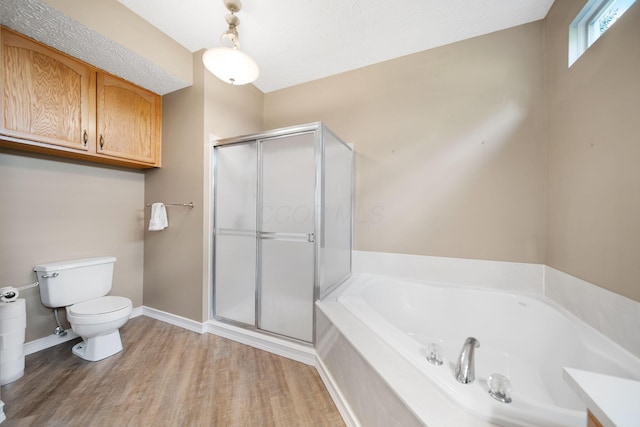 272 Trail E, Etna, OH 43062 - bathroom featuring toilet, a bath, a stall shower, wood finished floors, and baseboards