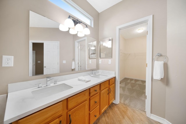 272 Trail E, Etna, OH 43062 - bathroom featuring double vanity, a spacious closet, and wood finished floors