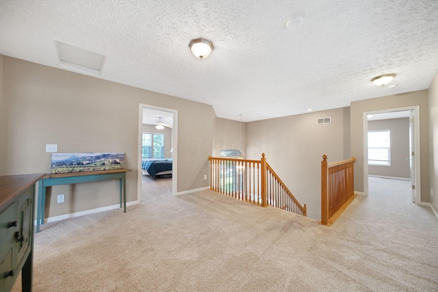 272 Trail E, Etna, OH 43062 - corridor with an upstairs landing, healthy amount of natural light, attic access, a textured ceiling, and carpet