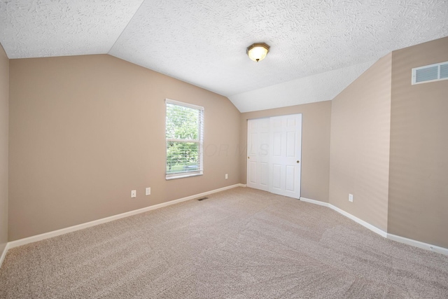 272 Trail E, Etna, OH 43062 - unfurnished bedroom featuring lofted ceiling, carpet, baseboards, a closet, and a textured ceiling