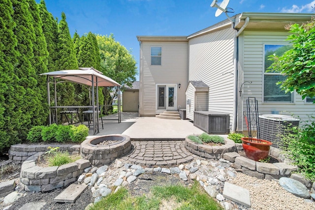 272 Trail E, Etna, OH 43062 - rear view of house featuring an outdoor fire pit, a patio area, central AC unit, and entry steps