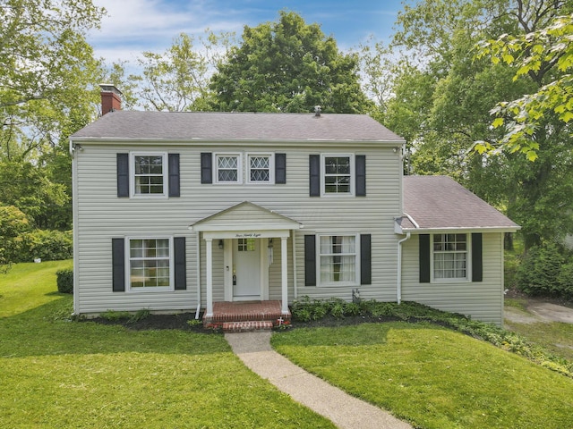 498 Manor, Newark, OH 43055 - colonial house featuring a chimney, a front lawn, and roof with shingles