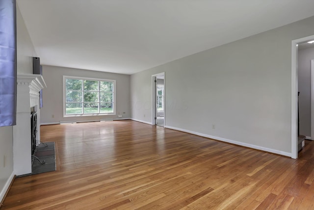 498 Manor, Newark, OH 43055 - unfurnished living room with light wood finished floors, baseboards, and a fireplace