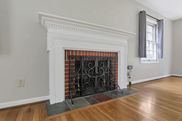 498 Manor, Newark, OH 43055 - detailed view of a brick fireplace, wood finished floors, and baseboards