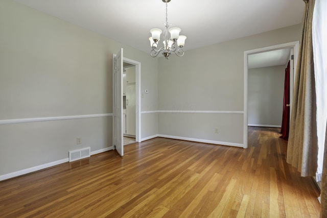 498 Manor, Newark, OH 43055 - spare room with a chandelier, hardwood / wood-style flooring, and baseboards