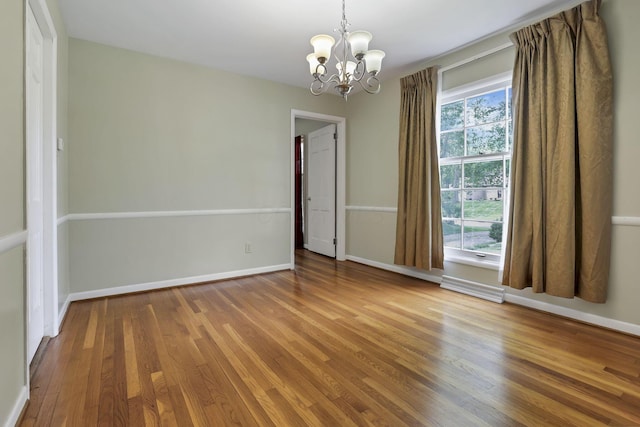 498 Manor, Newark, OH 43055 - unfurnished room featuring a chandelier, wood finished floors, and baseboards