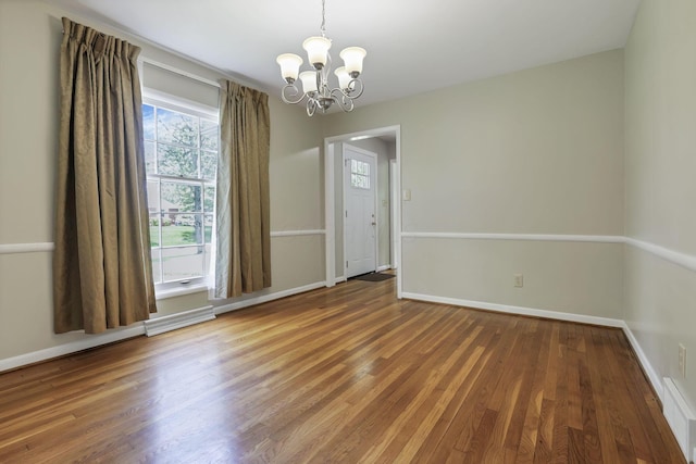 498 Manor, Newark, OH 43055 - unfurnished dining area featuring a chandelier, wood finished floors, and baseboards