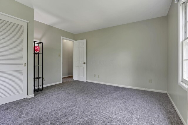 498 Manor, Newark, OH 43055 - unfurnished bedroom featuring dark carpet and baseboards