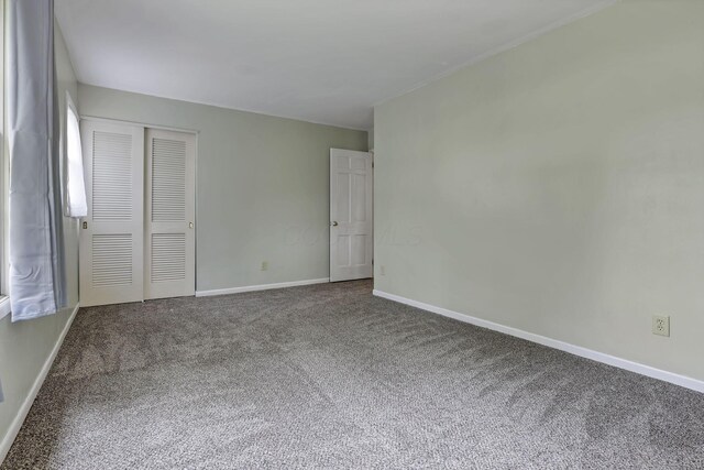 498 Manor, Newark, OH 43055 - unfurnished bedroom featuring carpet floors, a closet, and baseboards