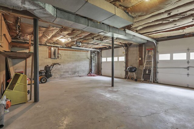 498 Manor, Newark, OH 43055 - garage featuring electric panel, a garage door opener, and concrete block wall