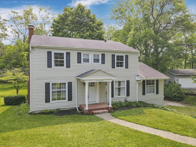 498 Manor, Newark, OH 43055 - colonial house featuring a chimney, a front lawn, and a shingled roof