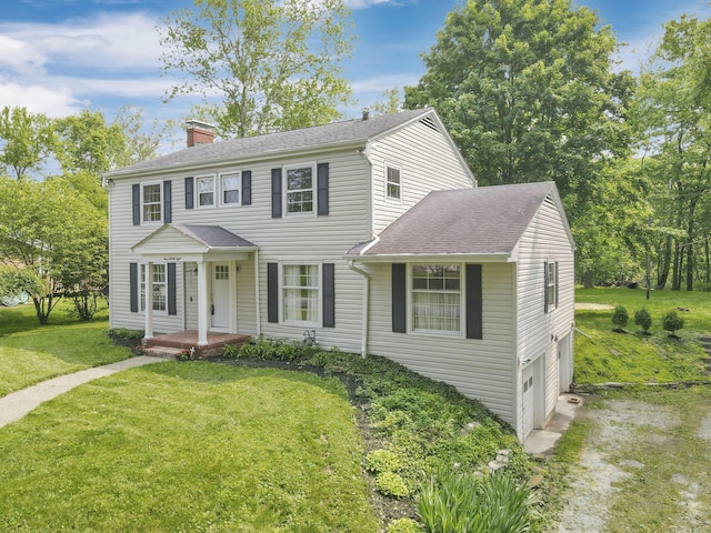 498 Manor, Newark, OH 43055 - colonial inspired home featuring a chimney, an attached garage, a front yard, and roof with shingles