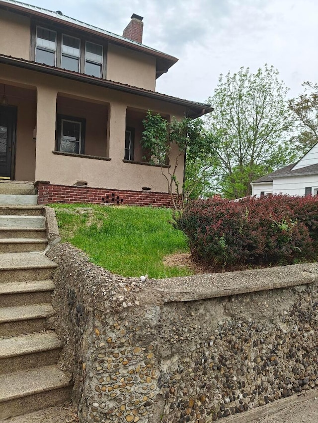 16 N 7th St, Newark, OH 43055 - view of side of home featuring a chimney and stucco siding