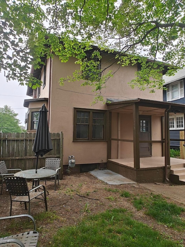 16 N 7th St, Newark, OH 43055 - rear view of house with fence, stucco siding, and a patio area