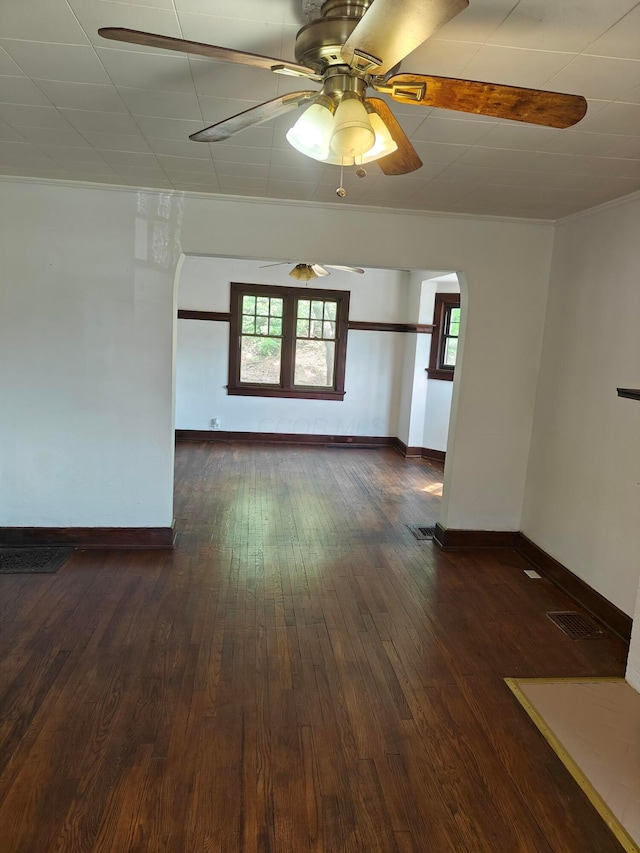 16 N 7th St, Newark, OH 43055 - spare room with arched walkways, a ceiling fan, baseboards, and dark wood-style flooring