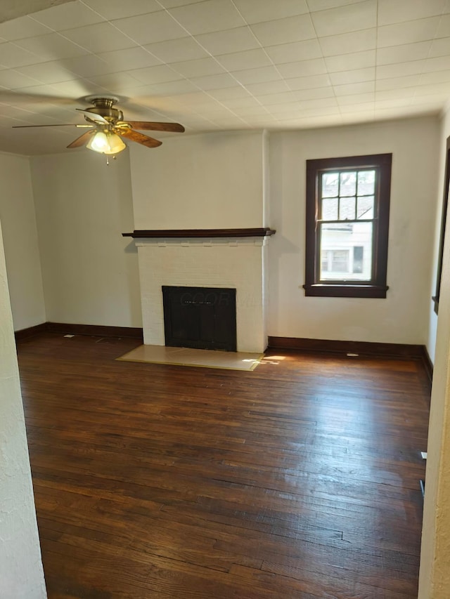 16 N 7th St, Newark, OH 43055 - unfurnished living room featuring baseboards, a fireplace, and dark wood-style flooring