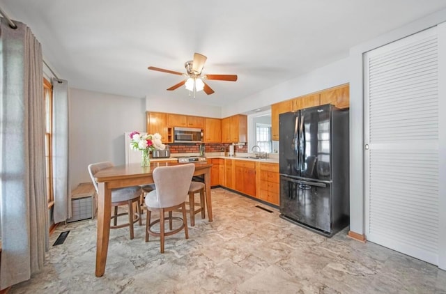 164 Sturbridge Rd, Columbus, OH 43228 - kitchen with freestanding refrigerator, stainless steel microwave, a sink, a ceiling fan, and light countertops
