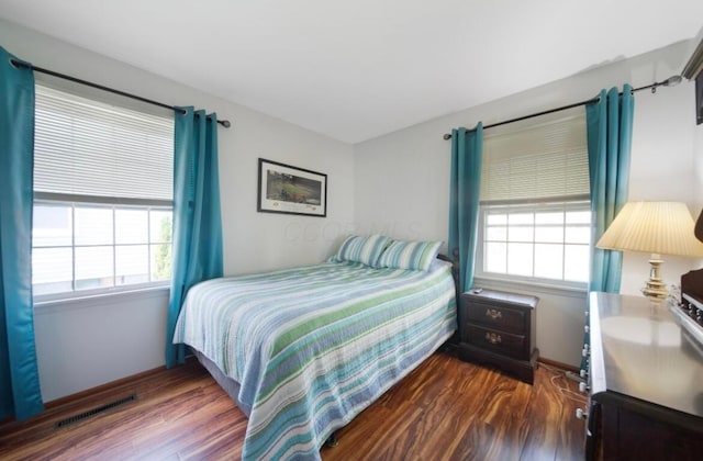 164 Sturbridge Rd, Columbus, OH 43228 - bedroom with multiple windows, dark wood-type flooring, and baseboards