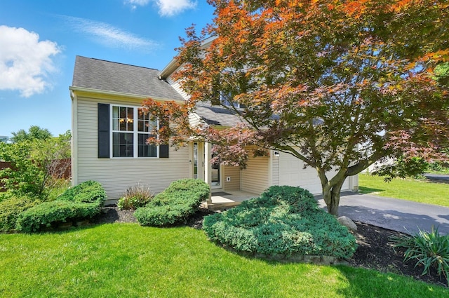 7221 Dewfall Dr, Reynoldsburg, OH 43068 - obstructed view of property with asphalt driveway, a front yard, and a shingled roof