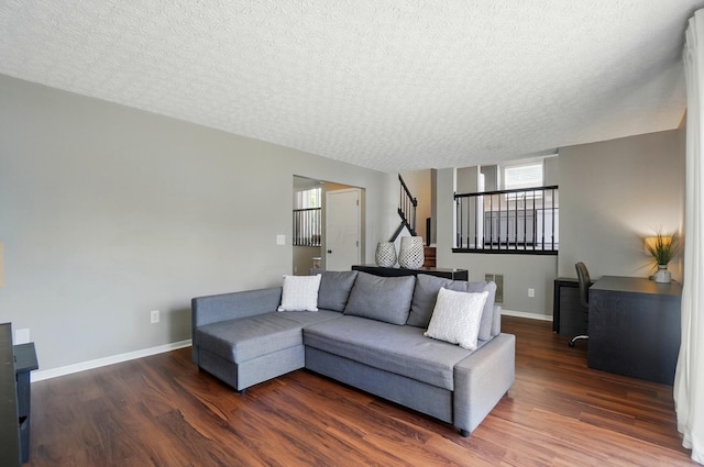 7221 Dewfall Dr, Reynoldsburg, OH 43068 - living room featuring a textured ceiling, wood finished floors, baseboards, and stairs