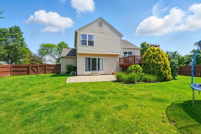 7221 Dewfall Dr, Reynoldsburg, OH 43068 - back of house with a patio area, a wooden deck, a trampoline, and a gate