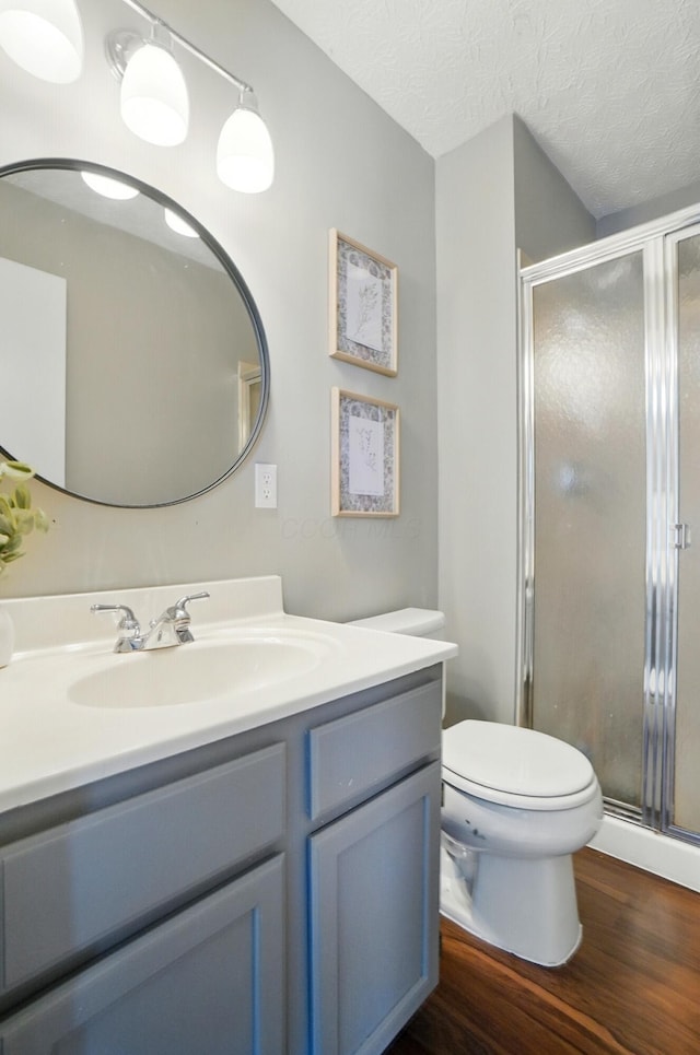 7221 Dewfall Dr, Reynoldsburg, OH 43068 - full bathroom with vanity, toilet, a shower stall, and wood finished floors