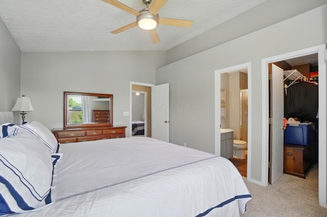 7221 Dewfall Dr, Reynoldsburg, OH 43068 - bedroom featuring a spacious closet, vaulted ceiling, light carpet, ensuite bath, and a closet