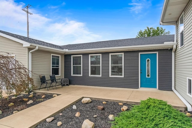 1267 N Dundee Trl, Bucyrus, OH 44820 - property entrance with a shingled roof and a patio