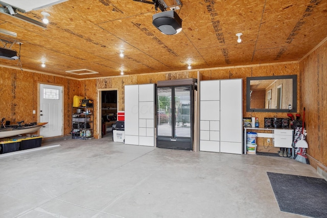 1267 N Dundee Trl, Bucyrus, OH 44820 - garage with wood walls and a garage door opener
