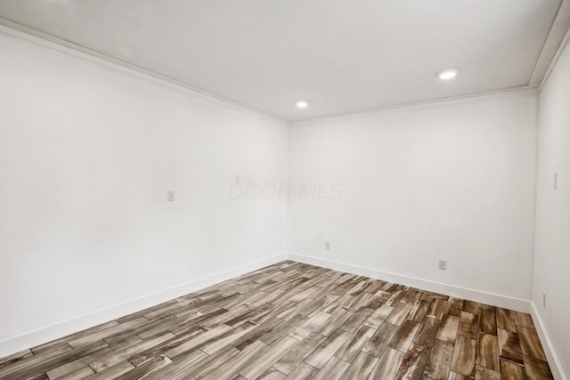 1267 N Dundee Trl, Bucyrus, OH 44820 - spare room featuring wood finished floors, crown molding, baseboards, and recessed lighting