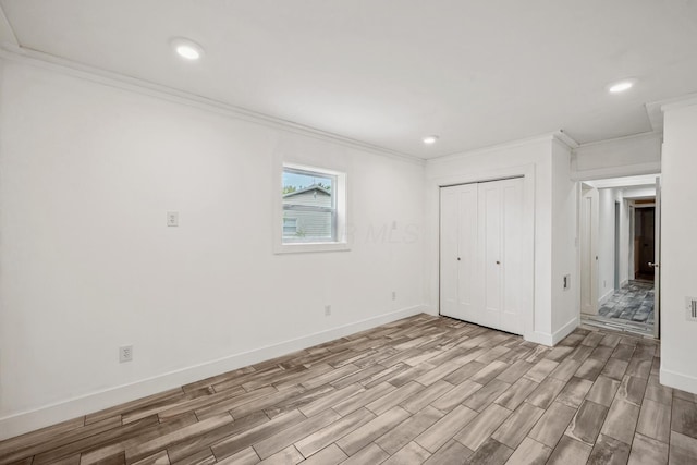 1267 N Dundee Trl, Bucyrus, OH 44820 - unfurnished bedroom with light wood finished floors, ornamental molding, baseboards, a closet, and recessed lighting