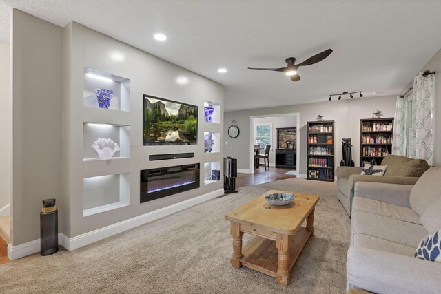 8270 Windy Hollow Rd, Johnstown, OH 43031 - living room with a ceiling fan, carpet, baseboards, recessed lighting, and a glass covered fireplace