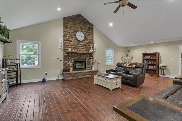 8270 Windy Hollow Rd, Johnstown, OH 43031 - living room with ceiling fan, vaulted ceiling, dark wood-style flooring, a large fireplace, and plenty of natural light