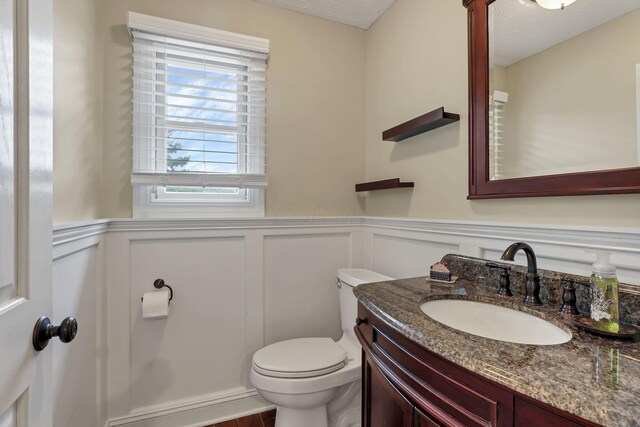 8270 Windy Hollow Rd, Johnstown, OH 43031 - half bath with toilet, vanity, a decorative wall, and a wainscoted wall