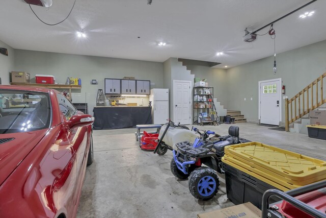 8270 Windy Hollow Rd, Johnstown, OH 43031 - garage featuring freestanding refrigerator, a garage door opener, and recessed lighting
