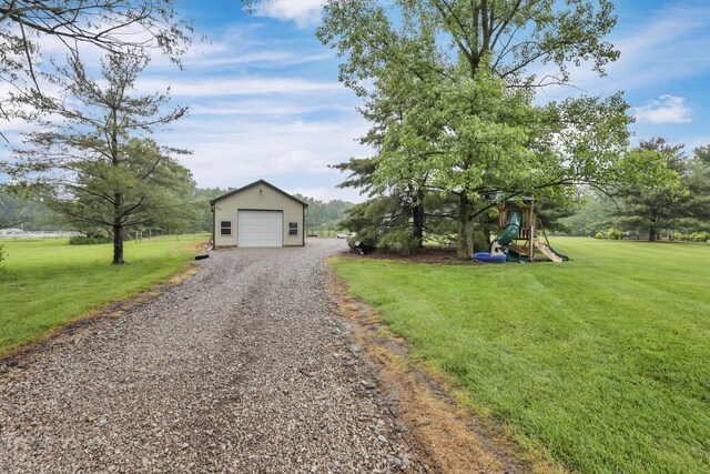 8270 Windy Hollow Rd, Johnstown, OH 43031 - view of front of property with a front yard, a playground, an outbuilding, and a garage