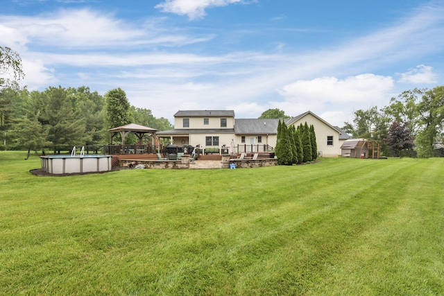 8270 Windy Hollow Rd, Johnstown, OH 43031 - view of green lawn with a gazebo, an outdoor pool, a patio area, and a wooden deck