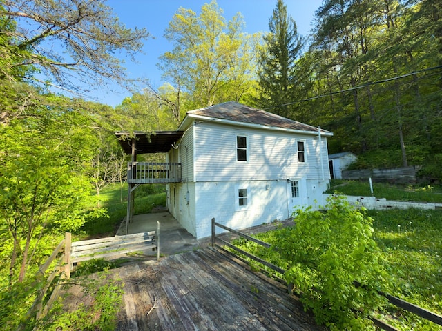 140 Sycamore St, Glouster, OH 45732 - rear view of house featuring a wooden deck and a wooded view