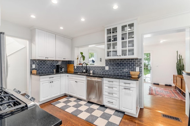 232 N Stanwood Rd, Columbus, OH 43209 - kitchen featuring stainless steel dishwasher, a sink, backsplash, glass insert cabinets, and white cabinets