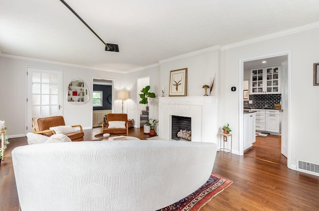 232 N Stanwood Rd, Columbus, OH 43209 - living room with ornamental molding, dark wood-type flooring, a fireplace, and baseboards