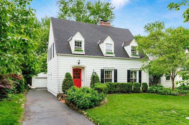 232 N Stanwood Rd, Columbus, OH 43209 - new england style home with an outdoor structure, a chimney, a front yard, a garage, and a shingled roof