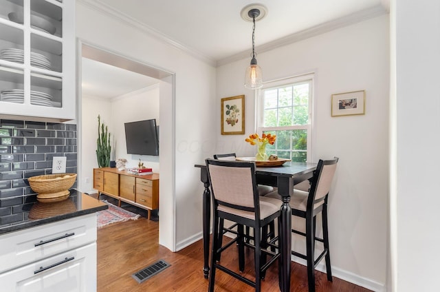 232 N Stanwood Rd, Columbus, OH 43209 - dining room with crown molding, dark wood-style floors, and baseboards