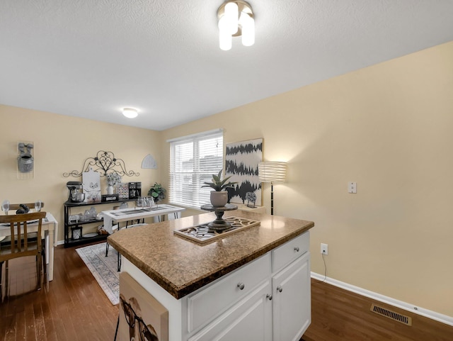 6010 Turnwood Dr Unit 703, Westerville, OH 43081 - kitchen with dark wood-style floors, white cabinetry, baseboards, and dark countertops