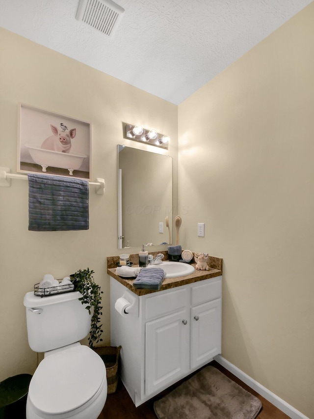 6010 Turnwood Dr Unit 703, Westerville, OH 43081 - bathroom featuring vanity, toilet, a textured ceiling, and baseboards