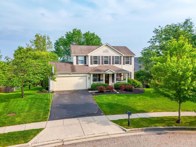 369 Highbanks Valley Ct, Newark, OH 43055 - colonial house featuring covered porch, driveway, a front yard, and an attached garage