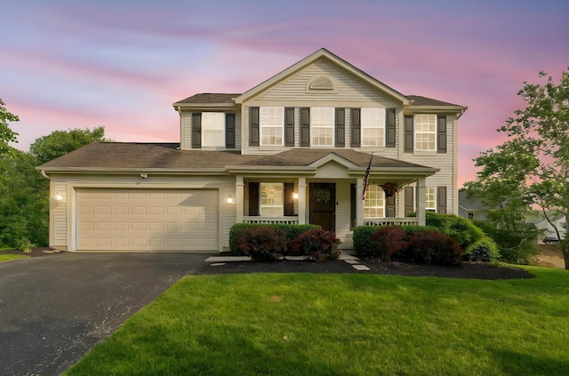 369 Highbanks Valley Ct, Newark, OH 43055 - view of front of house with asphalt driveway, covered porch, an attached garage, and a front lawn