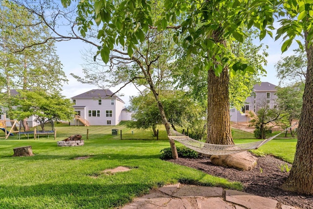 369 Highbanks Valley Ct, Newark, OH 43055 - view of grassy yard featuring a trampoline and an outdoor fire pit