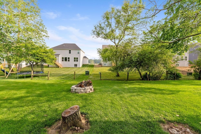 369 Highbanks Valley Ct, Newark, OH 43055 - view of grassy yard with a fire pit, a trampoline, and stairway